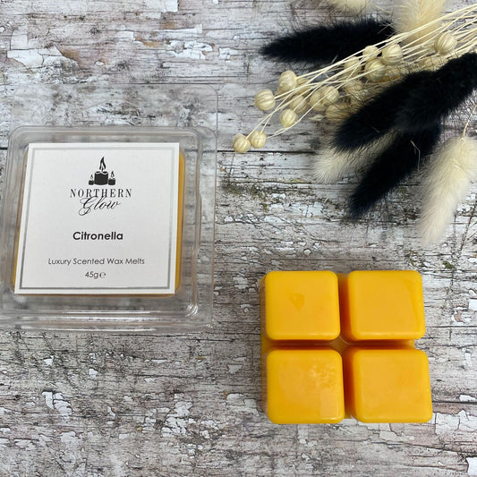 Citronella Wax Melt is a yellow colour square with four breakable cubes in a plastic case. The label is white with a silver borer and black writing. The logo is at the top with 'citronella' in the centre.